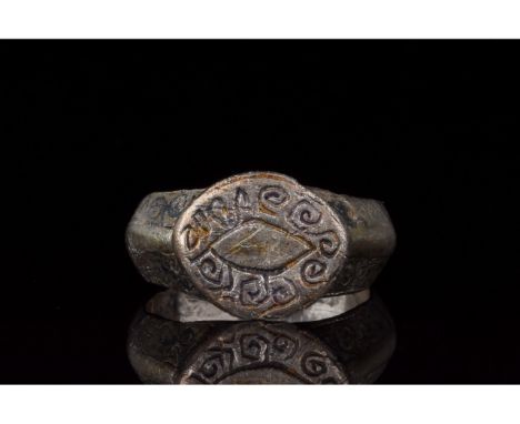 700-1100 AD. Viking era. A silver ring with a D-shaped hoop, with an elliptical bezel bearing an engraved â€œeyeâ€ motif, enc