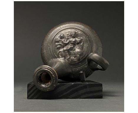 Ca. 500-400 BC. Ancient Greek. A rare terracotta guttus with a long spout with an out-turned rim; a squat, globular body with