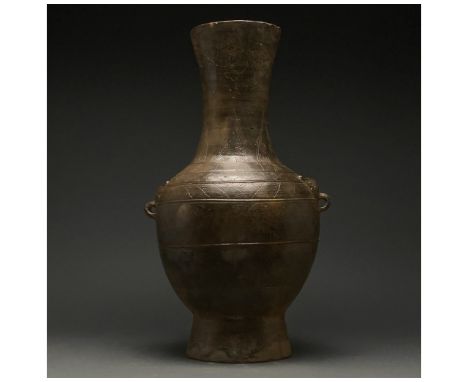 Ca. 206 BC-220 AD. Han Dynasty. A beautiful rare ceramic vase with a beige fabric and glossy brown slip. The vase comprises a