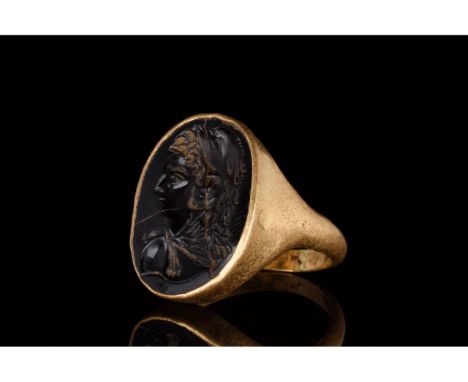 c. 100-300 AD. Roman. A rare gold ring with a circular hoop and elliptical bezel with a red hardstone setting engraved with a