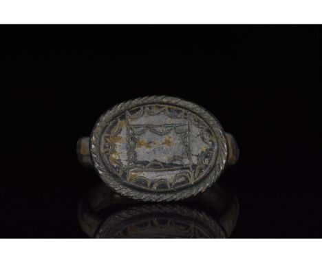 100-300 AD. Roman. A silvered bronze ring with a D-shaped hoop and elliptical plate bezel bearing an engraved border of semic