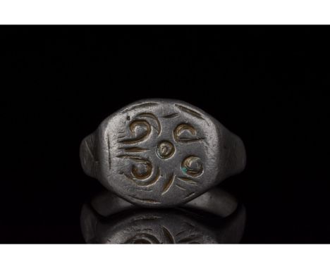 C. 700-1100 AD, Viking Age. A silver ring with a D-shaped hoop and a circular bezel with incised linear and curvilinear decor