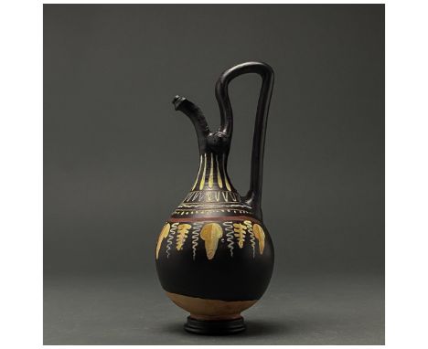 400-300 BC. Southern Italian. Gnathian oinochoe with elongated spout, constricted neck, piriform body, ring base and high, ea