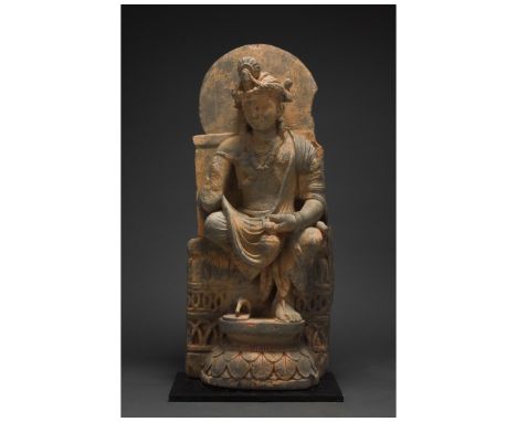 100-300 AD. Gandharan. A giant schist figure of a bodhisattva, backed by a halo, who sits, gazing serenely into the distance.