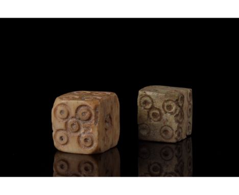 100-300 AD. Roman. A set of two bone dice with carefully carved dot-in-circle pips which are typical of dice of the Roman per