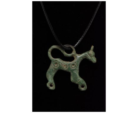 700-1100 AD, Viking Age. Bronze pendant showing a horned, winged beast, probably a dragon, in profile. In Norse mythology, FÃ