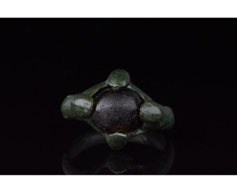 700-1100 AD, Viking Age. Bronze ring with a circular hoop, and a lozenge shaped bezel onto which is mounted a dark round ston