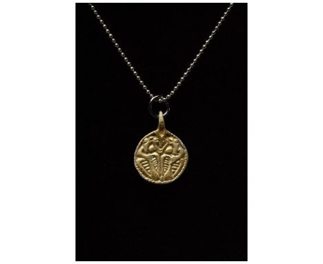 C. 700-1100. Viking Age. Silver gilt amulet featuring a disc shape with an integral suspension loop. The central section depi