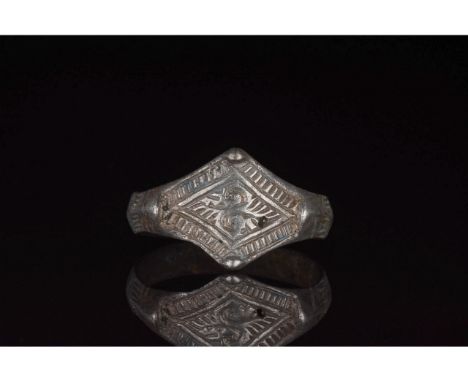 C. 700-1100 AD, Viking Age. A silver ring with a circular hoop and a lozenge-shaped bezel with incised linear and curvilinear