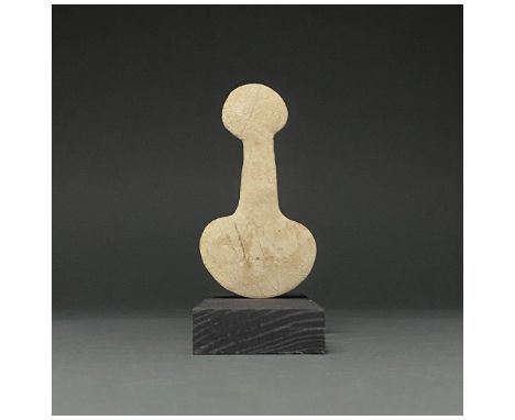 2700-2400 BC. Anatolian. A Kusura-type Anatolian idol cream-coloured stone, comprising a rounded body, long neck and sub-circ