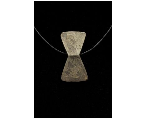 900-1100 AD, Viking Age. A silver example of a double axe or Perun amulet comprising a suspension loop and a double sided sty