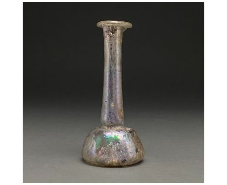 100-300 AD. Roman. Transparent glass unguentarium with outward flaring rim, long, slightly flaring neck and bell-shaped body.