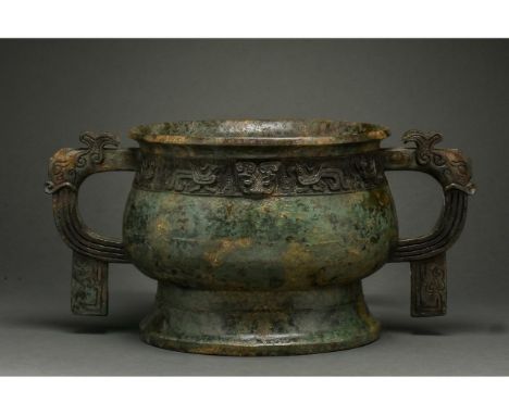 1100-900 BC. Early Western Zhou Dynasty. Bronze cast vessel Gui comprising a broad shelf-like lip, hemispherical bowl, wide l