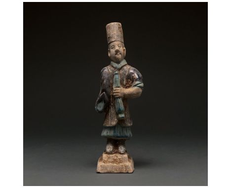 Ca. 1368-1644 AD. Chinese Ming Dynasty. An elaborately crafted male attendant figure dressed in a light blue tunic, a dark bl