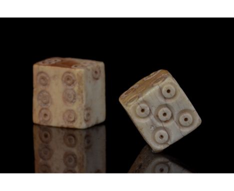 100-200 AD. Roman. A set of two bone dice with carefully carved dot-in-circle pips which are typical of dice of the Roman per