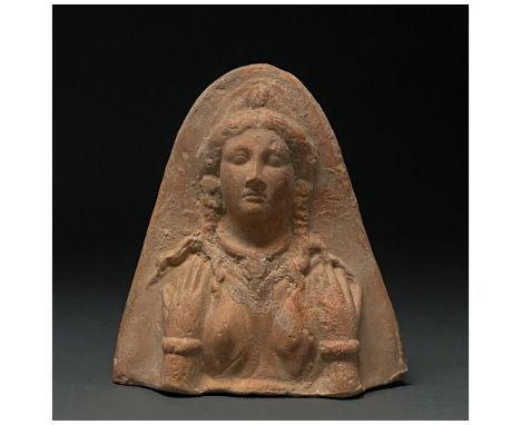 Ca.200-100 BC. A hollow-formed terracotta bust of a goddess wearing a high-girdled chiton and a radiate headdress; aperture t