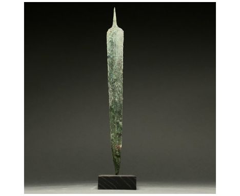 1200-700 BC, Greek Archaic Period. This beautiful cast bronze sword has a tapering, bevelled blade with a raised midrib and a