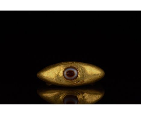 100-300 AD. Roman. Gold ring comprising a D-shaped hoop with broad sloping shoulders and an elliptical red and grey agate â€œ
