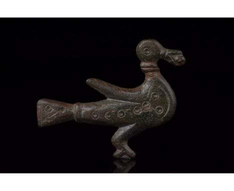 100-200 AD. Roman. A bronze zoomorphic brooch in the form of a duck in flight, holding a branch in its mouth. The duck bears 