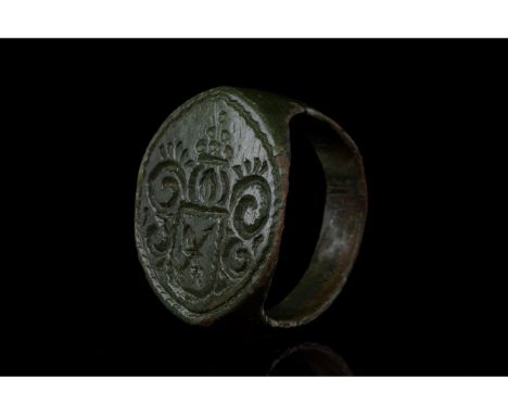 1100-1300 AD, Medieval. Bronze ring with D-shaped hoop and flattened, round bezel featuring incised decoration depicting a sh