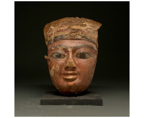 664â€“343 B.C. Late Dynastic / Ptolemaic Egyptian. A beautiful wooden mummy mask depicting an individual with ochre-coloured 