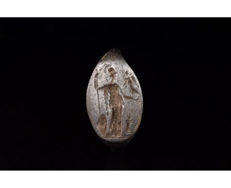 C. 100-300 AD. Roman. A silver ring with a D-shaped hoop and flattened, circular plate bezel. The engraved design on the beze