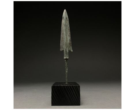 1200-700 BC, Greek Archaic Period. A bronze spearhead with a barbed, triangular, lentoid-sectioned blade with a raised midrib