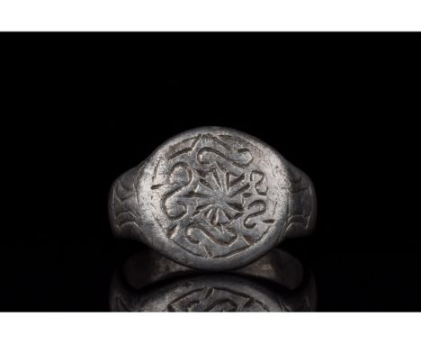 C. 700-1100 AD, Viking Age. A silver ring with a D-shaped hoop and a circular bezel with incised linear and curvilinear decor
