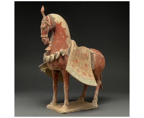 C. 386-534 AD. Northern Wei Dynasty. A painted pottery figure of a horse. The horse stands foursquare with its head drawn inw