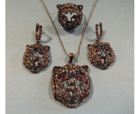 A silver, marcasite and ruby lion ring, and matching items