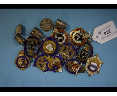 Assorted silver gilt and enamel Masonic fobs, and four thimbles
