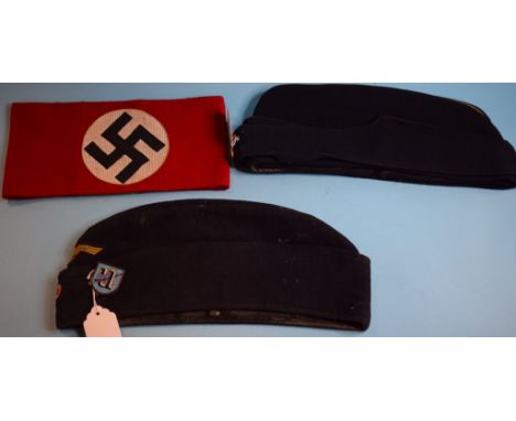 A Third Reich side cap, with a U-Boat flotilla enamel badge, an arm band, and an English side cap (3) Condition report Report