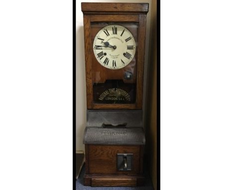 A National Time Recorder Co Ltd clocking in clock, in an oak case, 98 cm high