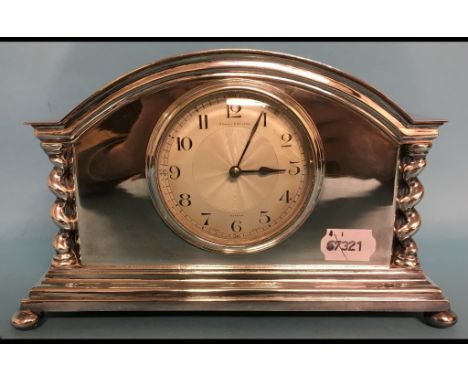 A mantel clock, with Arabic numerals, in a silver plated case, 15 cm high, and a pair of oak dining chairs (3)