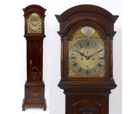 A longcase clock, the 30 cm square arched brass dial with silvered chapter ring, with Roman numerals, subsidiary seconds dial