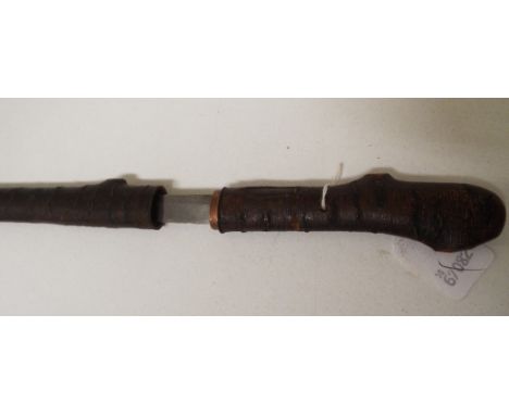 A Japanese short sword, having a 44 cm blade side, in a simulated wood scabbard, with matching handle, 86 cm long overall