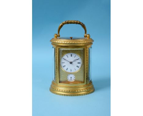 A carriage clock, with repeat, the 5.5 cm diameter enamel dial with Roman numerals above a subsidiary alarm dial, within a br