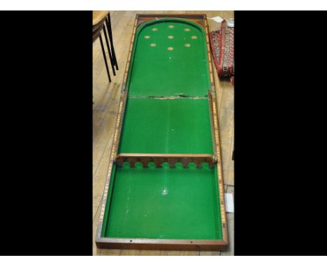 A folding bagatelle table, with balls 