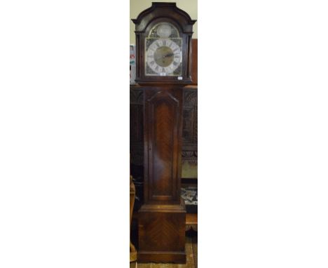 An 18th century style longcase clock, the 25 cm wide arched square dial with a silvered chapter ring having Roman numerals, a