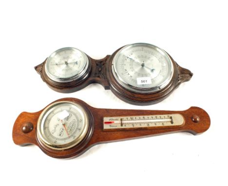 An Oak aneroid barometer with circular thermometer and one other