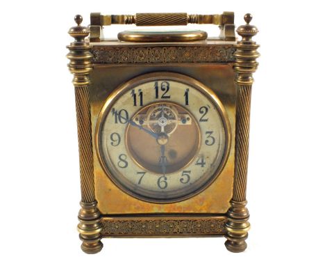 A substantial Brass carriage clock with column supports and decorative frieze with a painted chapter ring and visible escapem