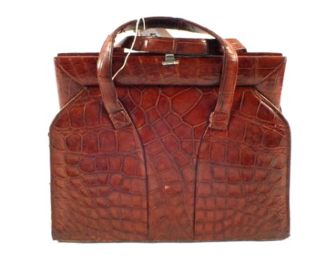 A vintage crocodile skin handbag