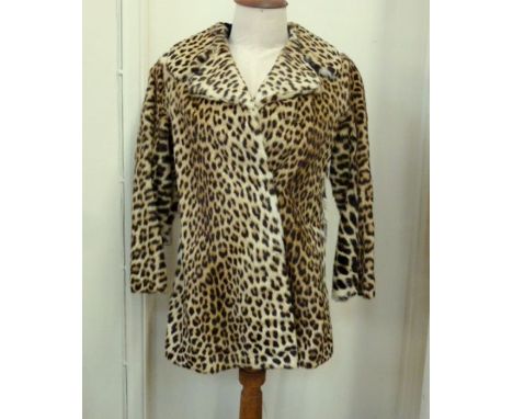 A vintage leopard skin coat labelled K. Borowski Johannesburg, CITES number 581257/01