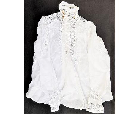 An Edwardian white cotton blouse, detailed with with lace on fine net, embroidered, pin-tucked and lace detail to the front a