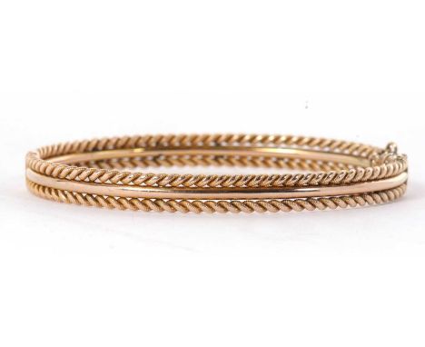 A gold hinged bangle, with plain centre section and rope twist border to either side, 6mm wide, concealed clasp with safety c