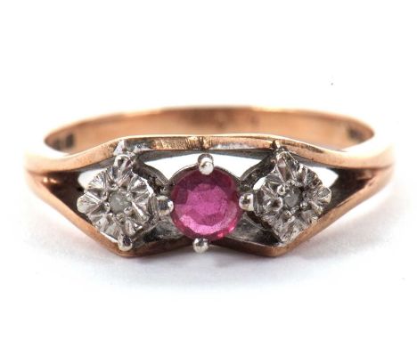 A 9ct ruby and diamond ring, the central claw mounted round ruby set to either side with a small illusion set diamond, all se