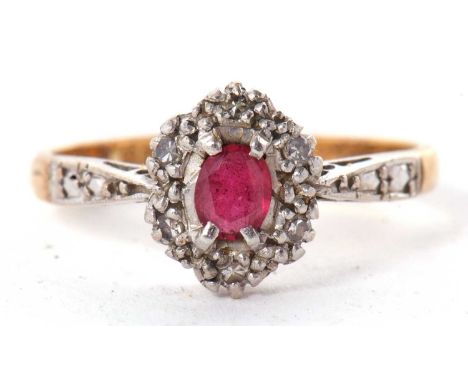 An 18ct and platinum ruby and diamond ring, the oval ruby with illusion set round single cut diamonds, all set in platinum wi