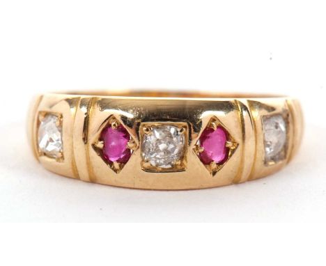 A late Victorian 18ct ruby and diamond ring, the alternating old mine cut diamonds and round rubies, countersunk in a taperin