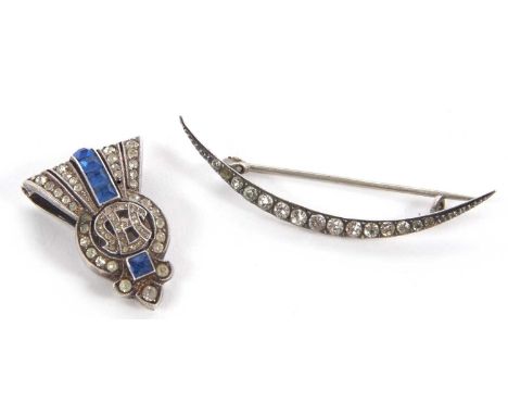 Two 20th century brooches, the first a continental silver crescent moon shape brooch set with white paste, stamped 935 to rev