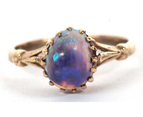 A 9k opal ring, the oval opal cabochon, claw mounted to a plain band indistinctly stamped 9k, size M, 2.4g